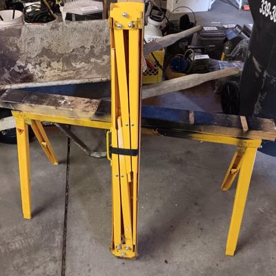 PAIR OF FOLDING METAL ADJUSTABLE HEIGHT SAW HORSES AND A WHEEL BARROW