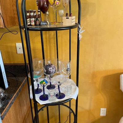 Black metal wine bottle holder and shelving including glasses