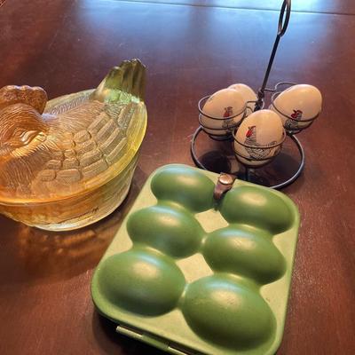 Glass hen on a nest with eggs and metal egg holder