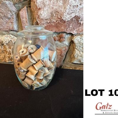 Large jar with wooden thread spools