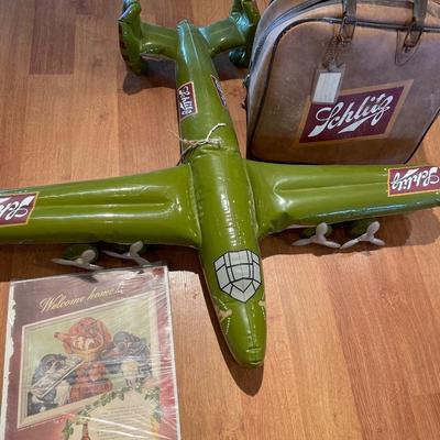Schlitz airplane, bowling bag and paper ad