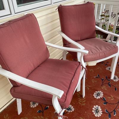 Red outdoor chairs and red rug