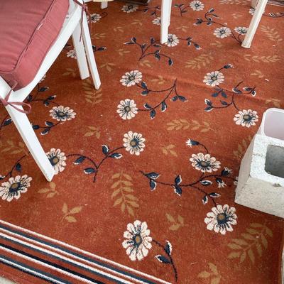 Red outdoor chairs and red rug