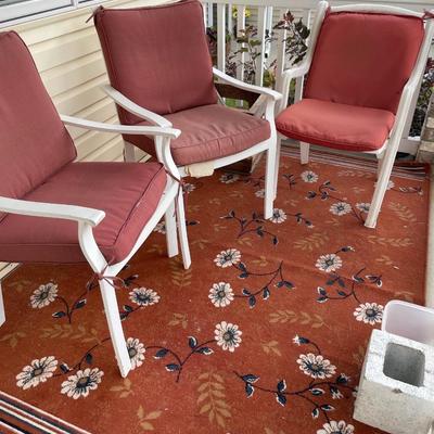Red outdoor chairs and red rug
