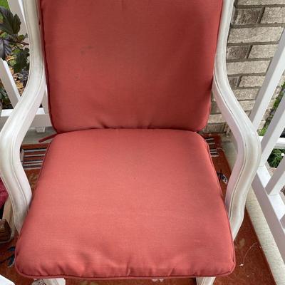 Red outdoor chairs and red rug