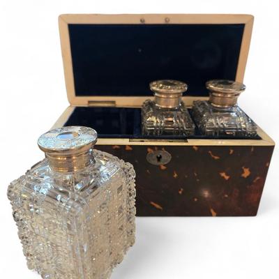 Sale Photo Thumbnail #47: Rectangualr scnt box. Lined blue velvt. 3 Cut crystal bottles. Monogrammed silver medallion on domed lid.
6.75 x 3.25 x 4.5h