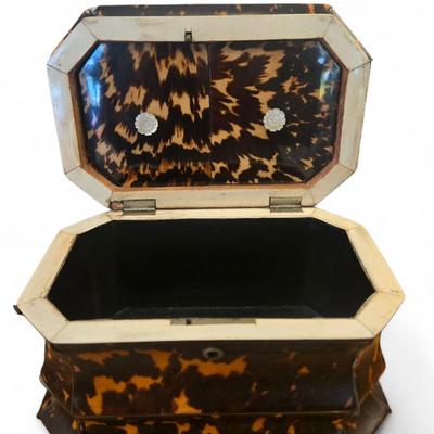 Sale Photo Thumbnail #43: Tortoise tea caddy England. C. 1860 pagoda shape. Silver top plate not monogrammed. Sits on bun feet. Polishd lids inset into top.
8.25 x 5.25 x 6h