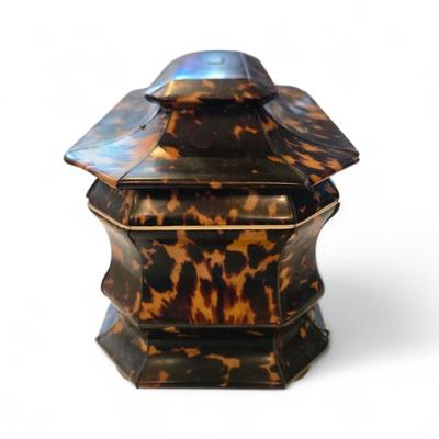Sale Photo Thumbnail #42: Tortoise tea caddy England. C. 1860 pagoda shape. Silver top plate not monogrammed. Sits on bun feet. Polishd lids inset into top.
8.25 x 5.25 x 6h