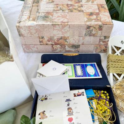 Fancy storage boxes, fancy scapbook paper pads, flowers and gold trims