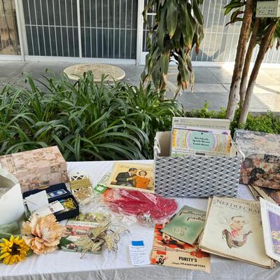 Fancy storage boxes, fancy scapbook paper pads, flowers and gold trims