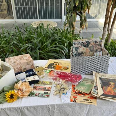 Fancy storage boxes, fancy scapbook paper pads, flowers and gold trims