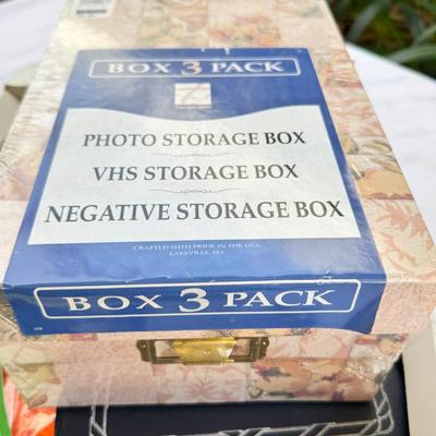 Fancy storage boxes, fancy scapbook paper pads, flowers and gold trims