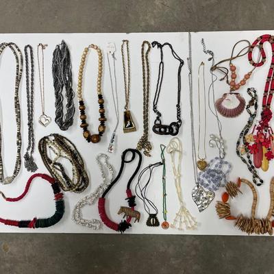 Sale Photo Thumbnail #223: Huge lot full of all sorts of fun necklaces! Hawaiian, African, silver statement piece, possibly some coral. Lots of cool, kitschy pieces.