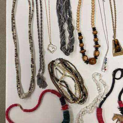 Sale Photo Thumbnail #224: Huge lot full of all sorts of fun necklaces! Hawaiian, African, silver statement piece, possibly some coral. Lots of cool, kitschy pieces.