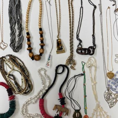 Sale Photo Thumbnail #225: Huge lot full of all sorts of fun necklaces! Hawaiian, African, silver statement piece, possibly some coral. Lots of cool, kitschy pieces.