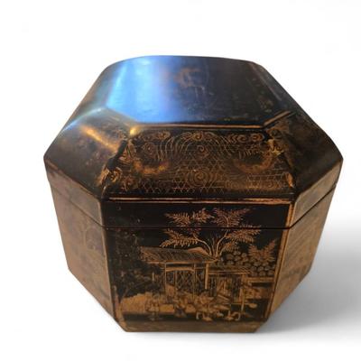 Sale Photo Thumbnail #90: Excellent tea caddy with all imserts and lids intact.
Hand-crafted in China for the European market, this English black lacquered octagonal hinged tea caddy features a decorative stenciled motif of pagodas and foliage in gilt, which contrasts beautifully 