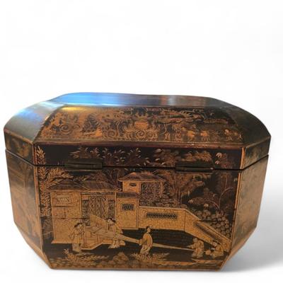 Sale Photo Thumbnail #91: Excellent tea caddy with all imserts and lids intact.
Hand-crafted in China for the European market, this English black lacquered octagonal hinged tea caddy features a decorative stenciled motif of pagodas and foliage in gilt, which contrasts beautifully 