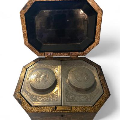 Sale Photo Thumbnail #87: Excellent tea caddy with all imserts and lids intact.
Hand-crafted in China for the European market, this English black lacquered octagonal hinged tea caddy features a decorative stenciled motif of pagodas and foliage in gilt, which contrasts beautifully 