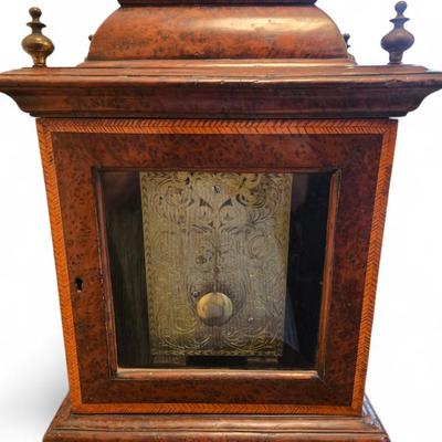 Sale Photo Thumbnail #102: Fine example of 18th C. George II bracket mantle clock with burl and fruitwood inlays. Signed John Smallwood Macclesfield. Keyed doors at front and back display face and engraved and chased works. Handle at top. Face and back interiors are framed by ornat