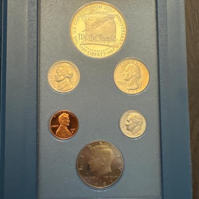 Sale Photo Thumbnail #34: Includes box, book, COA, 6 coins encased. 
Lincoln cent 
Jefferson nickel 
Roosevelt dime
Washington quarter 
Kennedy half dollar 
Constitution Proof (90% Silver - 26.730 grams)