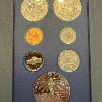 Sale Photo Thumbnail #45: Includes box, book, 7 coins, spec sheet. 
Coins include: 
Lincoln Penny 
Jefferson nickel 
Roosevelt dime 
Washington quarter 
Kennedy half 
Liberty half dollar 
Liberty silver dollar (90% Silver) 
All minted in San Francisco