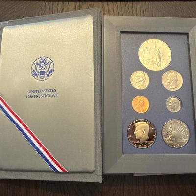 Sale Photo Thumbnail #42: Includes box, book, 7 coins, spec sheet. 
Coins include: 
Lincoln Penny 
Jefferson nickel 
Roosevelt dime 
Washington quarter 
Kennedy half 
Liberty half dollar 
Liberty silver dollar (90% Silver) 
All minted in San Francisco