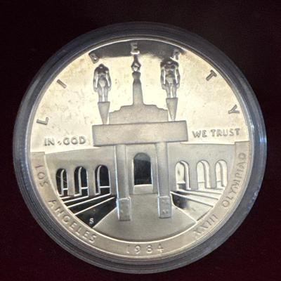 Sale Photo Thumbnail #114: Proof coins 
Each made of 90% Silver and minted in San Francisco. 

1983 discusses thrower with bust of American eagle on reverse. 

1984 Gateway to Olympic Colosseum with American eagle on reverse. 

Each coin is 1.50inches in diameter weighing .86 Troy 