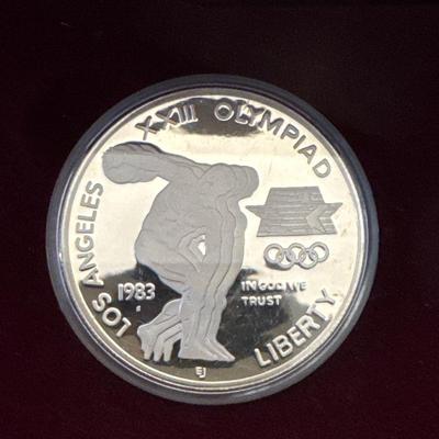 Sale Photo Thumbnail #113: Proof coins 
Each made of 90% Silver and minted in San Francisco. 

1983 discusses thrower with bust of American eagle on reverse. 

1984 Gateway to Olympic Colosseum with American eagle on reverse. 

Each coin is 1.50inches in diameter weighing .86 Troy 
