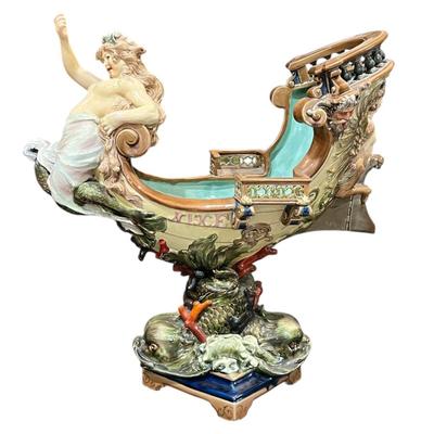 Sale Photo Thumbnail #345: 24" Tall, Missing a Staff or sword. Antique! Collectible. 
Very large and imposing majolica, Baroque revival centerpiece of a river mermaid riding a Spanish galleon. This piece is titled NIXE, a water sprite of German origin. It is unmarked but may possib