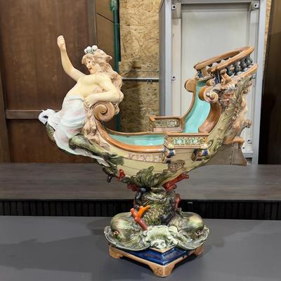 Sale Photo Thumbnail #332: 24" Tall, Missing a Staff or sword. Antique! Collectible. 
Very large and imposing majolica, Baroque revival centerpiece of a river mermaid riding a Spanish galleon. This piece is titled NIXE, a water sprite of German origin. It is unmarked but may possib