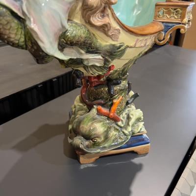 Sale Photo Thumbnail #337: 24" Tall, Missing a Staff or sword. Antique! Collectible. 
Very large and imposing majolica, Baroque revival centerpiece of a river mermaid riding a Spanish galleon. This piece is titled NIXE, a water sprite of German origin. It is unmarked but may possib
