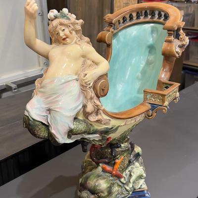 Sale Photo Thumbnail #333: 24" Tall, Missing a Staff or sword. Antique! Collectible. 
Very large and imposing majolica, Baroque revival centerpiece of a river mermaid riding a Spanish galleon. This piece is titled NIXE, a water sprite of German origin. It is unmarked but may possib