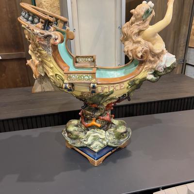 Sale Photo Thumbnail #338: 24" Tall, Missing a Staff or sword. Antique! Collectible. 
Very large and imposing majolica, Baroque revival centerpiece of a river mermaid riding a Spanish galleon. This piece is titled NIXE, a water sprite of German origin. It is unmarked but may possib