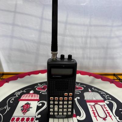 Sale Photo Thumbnail #790: The image shows a RadioShack Pro-404 Handheld Scanner, also known by its model number 20-404. 
This scanner is designed for receiving various radio communications and features:
200 Channels: It can store up to 200 channels for monitoring various frequenci