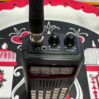 Sale Photo Thumbnail #792: The image shows a RadioShack Pro-404 Handheld Scanner, also known by its model number 20-404. 
This scanner is designed for receiving various radio communications and features:
200 Channels: It can store up to 200 channels for monitoring various frequenci