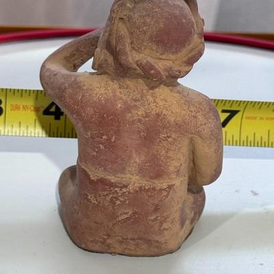 Sale Photo Thumbnail #160: The figure in your image is a Vintage "Portrait of Anxiety/Depression" Clay Pottery Figure, which is a 1960s promotional piece for a prescription drug company in Mexico, believed to be Etrafon. 
Here's more information about this intriguing figure:
Origin