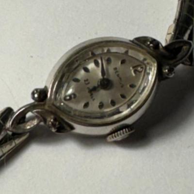 Sale Photo Thumbnail #378: Bulova ladies' watch with a silver-toned band and an oval face. The dial features the words "Bulova" and "23 Jewels," indicating it's likely a part of or related to the Bulova 23 series. This series of watches, known for its 23-jewel movement, debuted in 