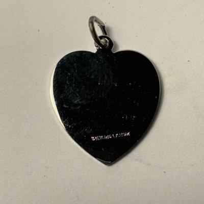 Sale Photo Thumbnail #392: heart-shaped charm with the words "Happy Anniversary" engraved on it. made of sterling silver.