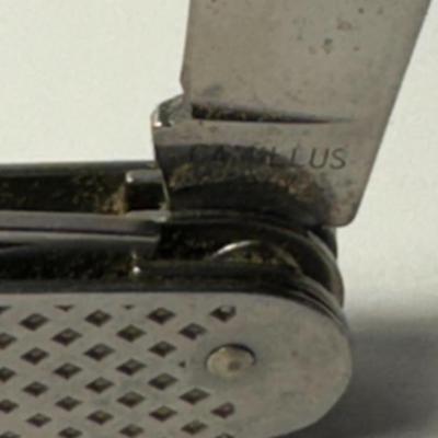 Sale Photo Thumbnail #748: Military Issue: MIL-K-818 four-blade utility knife, which is  the one shown in the image. They were issued to various military services and were also available commercially.