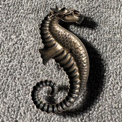 Sale Photo Thumbnail #425: Steampunk Sea Dragon or Seahorse pendant  a distinctive piece of jewelry that blends Victorian-era aesthetics with industrial and mechanical elements. 
Here's a breakdown of its features and context:
Design: The pendant  features a creature resembling a s