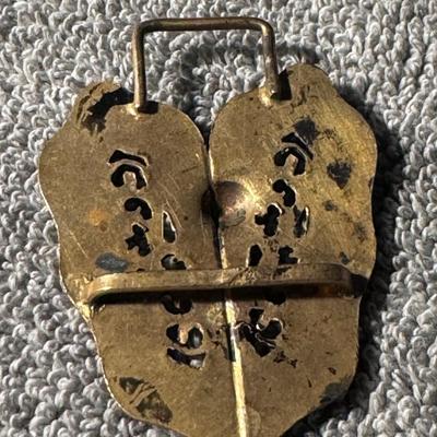 Sale Photo Thumbnail #460: Antique Victorian Filigree Belt Buckle. 
Here's more information about this type of item:
Period and Style: This ornate, gold-tone metal buckle likely dates to the late 19th or early 20th century, consistent with the Victorian or Edwardian eras and their 