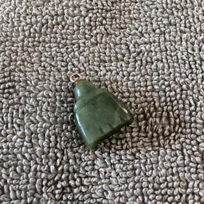 Sale Photo Thumbnail #531: Jade Buddha Pendant. 
Here's some information about it:
Material: It is carved from jade, often specifically nephrite jade, known for its green hues and durability.
Symbolism: The Buddha figure, particularly the Laughing Buddha (Budai), symbolizes happine