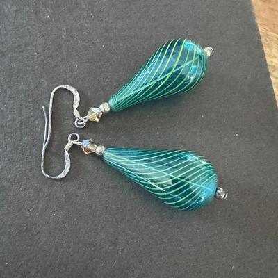 Sale Photo Thumbnail #576: Hand Blown Lampwork Glass Teardrop or Pear-Shaped Dangle Earrings. 
Here's more information about these earrings:
Material and Construction: The prominent feature is the tear-drop or pear-shaped bead, which is made of hand-blown, hollow glass, often using