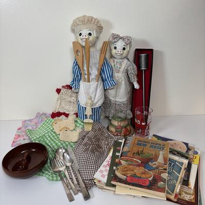 LOT 73: Porcelain Chef Pig & Assistant, Vintage Aprons & Cookbooks, Flatware, Cherry Wood Bowl & More