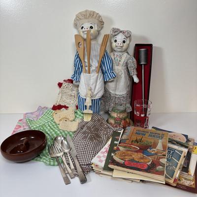 LOT 73: Porcelain Chef Pig & Assistant, Vintage Aprons & Cookbooks, Flatware, Cherry Wood Bowl & More