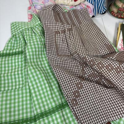 LOT 73: Porcelain Chef Pig & Assistant, Vintage Aprons & Cookbooks, Flatware, Cherry Wood Bowl & More