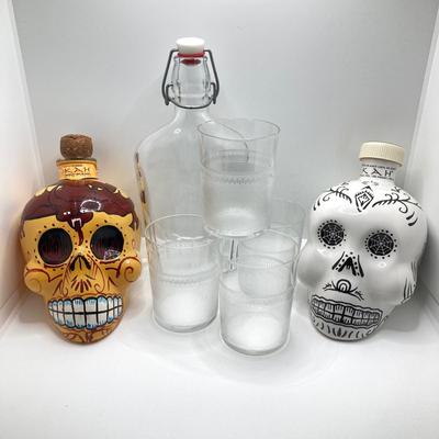 LOT 177: Pair of Kah Tequila Scull Bottles / Decanters, Set of Four Rocks Glasses and Glass Bottle with Wire Bail Swing Top Lid