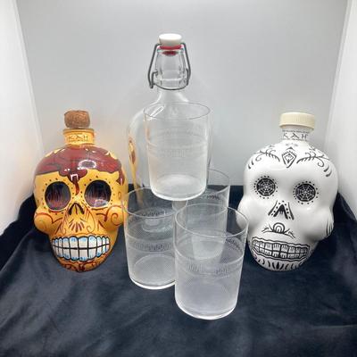 LOT 177: Pair of Kah Tequila Scull Bottles / Decanters, Set of Four Rocks Glasses and Glass Bottle with Wire Bail Swing Top Lid