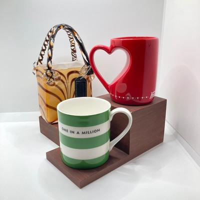 LOT 178: Lenox Kate Spade One In A Million Mug, Art Glass Animal Print Handbag Vase, Leather Coach Hang Tag and Krispy Kreme Mug