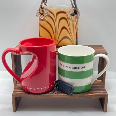 LOT 178: Lenox Kate Spade One In A Million Mug, Art Glass Animal Print Handbag Vase, Leather Coach Hang Tag and Krispy Kreme Mug